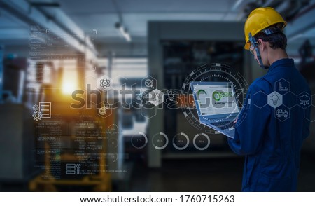Industry 4.0 Robot concept .Engineers use laptop computers for machine maintenance, automation tools, robot arm at the factory. Royalty-Free Stock Photo #1760715263