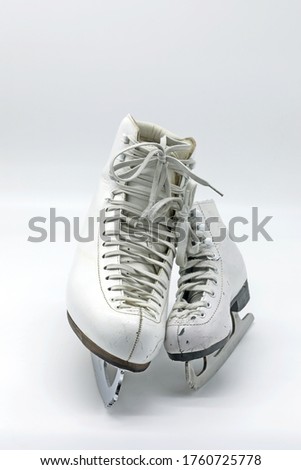 Big and small ice skating boots with laces on white background