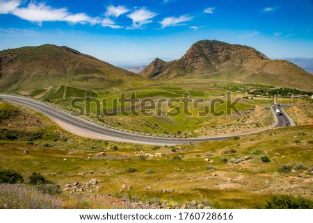 asphalt road in the mountains under sky