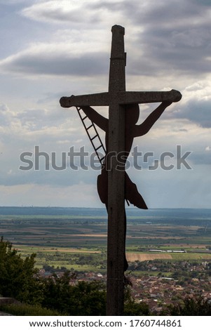 The symbol of the crucifixion of Jesus dominates the city.