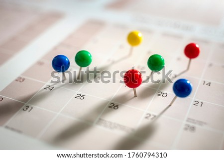 Thumbtack pins in calendar concept for busy, appointment and meeting reminder Royalty-Free Stock Photo #1760794310