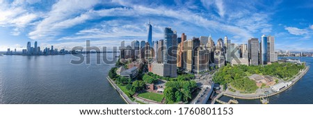 Aerial panorama of New York City skyline at sunset with both Battery park and downtown Manhattan