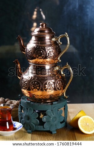 Copper teapot on metal gas cooker
