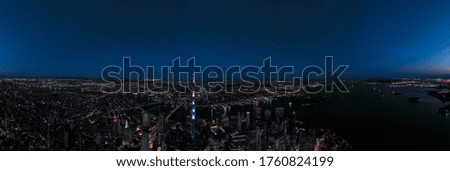 Aerial panorama of New York City skyline at sunset with both Brooklyn and downtown Manhattan