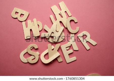 Wooden alphabets letter on pink background. education concept image