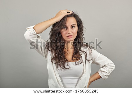 Forgetful holding hand to hair, touches head forgot something important regrets about mistake feels stressed, bad memory absent-mindedness, facepalm disappointed, slapping forehead, oversight Royalty-Free Stock Photo #1760855243