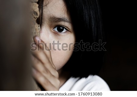 Little girl with eye sad and hopeless. Human trafficking and fear child concept.  Royalty-Free Stock Photo #1760913080