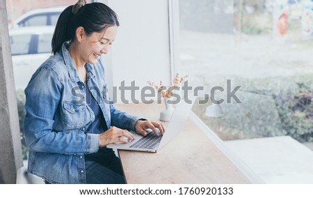 using computer.hand typing keyboard laptop online chatting search form internet while working sitting at coffee shop.concept for.technology device contact communication business people