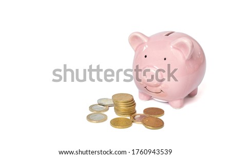 Pink piggy bank and money tower on white background. Finance and saving money concept.