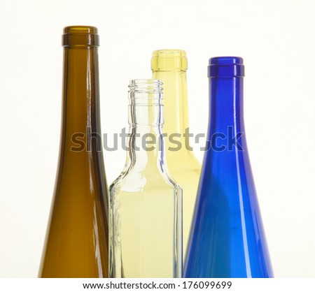 close-up of colored glass bottle necks isolated on white background studio