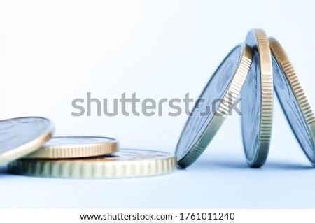  pennies lie unusually on a blue background. High quality photo