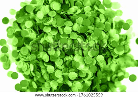 Green confetti background. Flat lay style. Festive concept