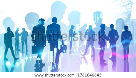 Silhouettes of business people working together in blurry abstract city with double exposure of digital graph and world map. Concept of teamwork and business lifestyle. Toned image