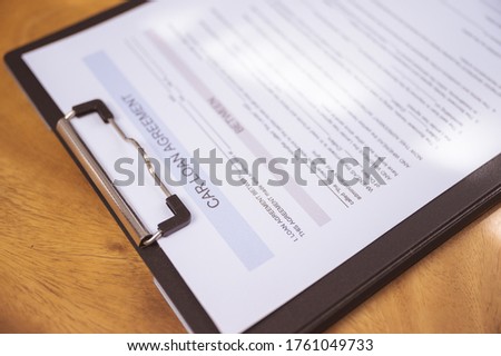 Car loan agreement paper on wood table