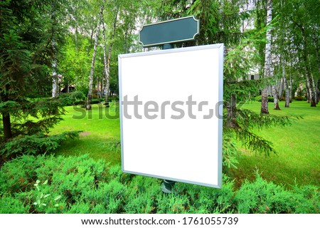 White empty signboard mockup  in a green park