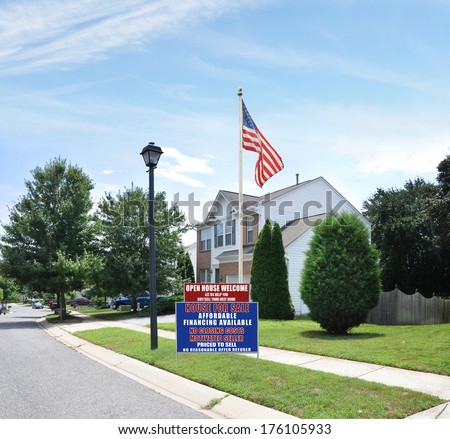 American Flag Real Estate Open House For sale Sign Suburban McMansion Home Residential neighborhood USA Blue Sky Clouds