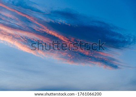 Dark blue sky before sunset with beautiful awesome clouds. Colorful Sunset Background