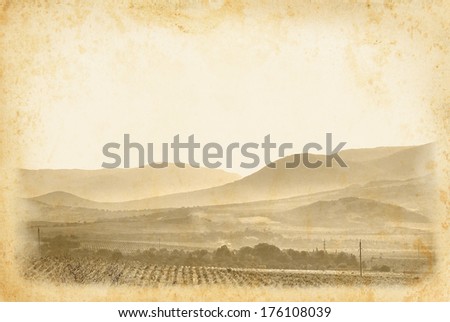 Wine label for your design. Vintage wine poster at old paper background. Ancient framed page with vineyard and mountain landscape.