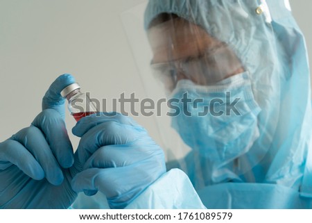 Doctor holds an ampoule with medicine