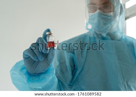 Doctor holds an ampoule with medicine
