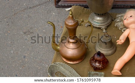 A flea market with a large assortment of Antiques, copper jugs and trinkets for sale.