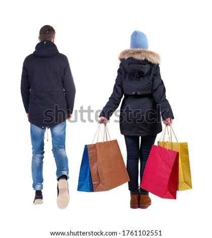 back view of couple with shopping bags in winter jacket. backside view of person. Rear view people collection. Isolated over white background.
