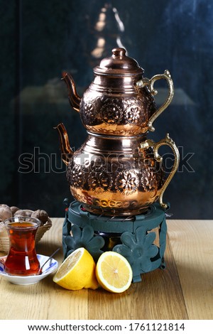 Copper teapot on metal gas cooker
