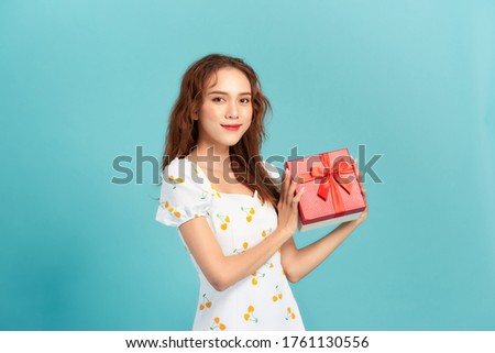 happy girl with gift box over blue