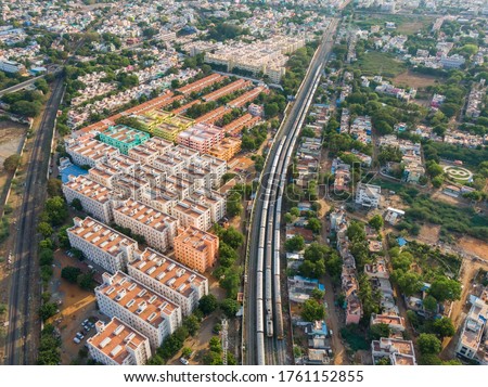 drone shot aerial view of madurai tamilnadu cityscape cloudy weather railway line trains mountains wallpaper background 