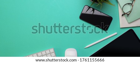 Top view of copy space on creative worktable with digital devices and decoration
