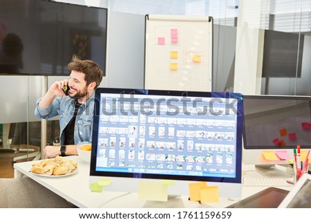 Workplace with computer monitor in an internet agency with business man