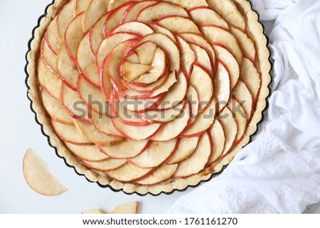 Homemade delicious baked  red Apple tart against white background. flat lay, top view, Copy space. Holidays, thanksgiving, Christmas, French cuisine concept.  