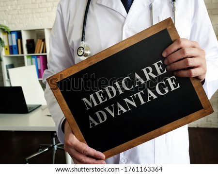 A Doctor shows a tablet Medicare advantage. Royalty-Free Stock Photo #1761163364