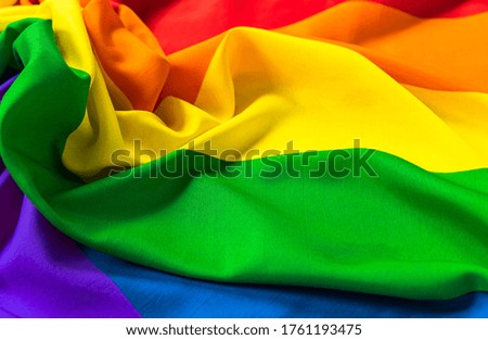 Rainbow LGBT flag of six colors for design with space for text. Copy space. Symbol of the LGBT movement. Rainbow silk fabric.