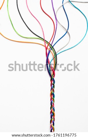 Coloured String Woven Together To Illustrate Concepts Of Unity Society Togetherness and Cooperation Royalty-Free Stock Photo #1761196775