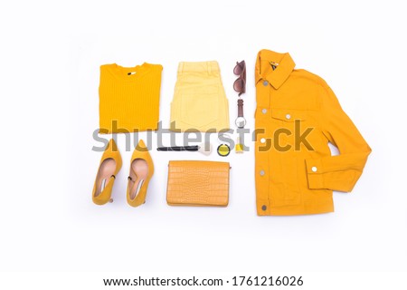 flat lay of woman yellow jeans jacket clothes and accessories, Cosmetic Makeup Set., with handbag. Trendy fashion female background Royalty-Free Stock Photo #1761216026