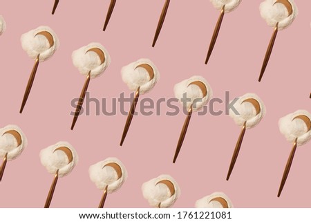 rose gold metallic spoon with powder pattern on a pink background