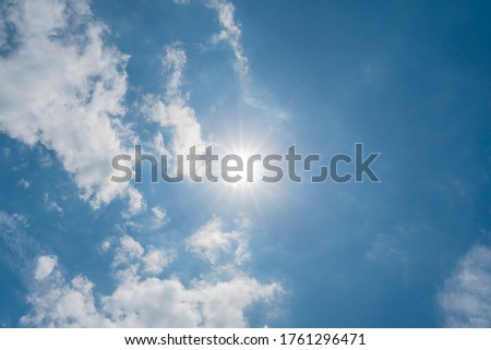 The sun in the navy blue heaven in the summer sunny day. Clouds and sun in the sky copy space Royalty-Free Stock Photo #1761296471