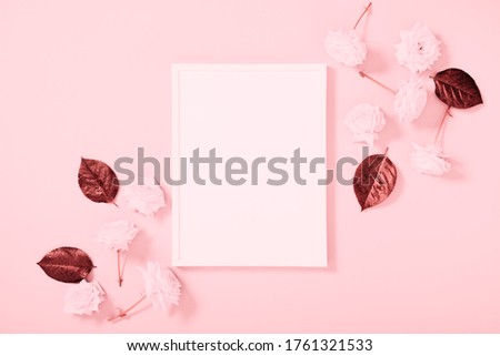 Beautiful flowers composition. Pink roses on pink background. Blank frame for text, pink flowers on pastel pink table. Flat lay, top view, copy space