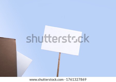 Holding a blank sign at a demonstration. Poster for the copy space with blue background.