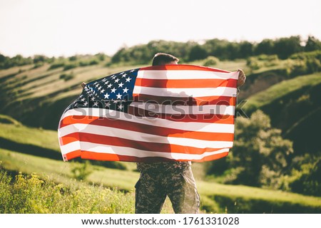American soldier with usa flag on his back looks into the distance.
United States Army. Veterans Day Royalty-Free Stock Photo #1761331028