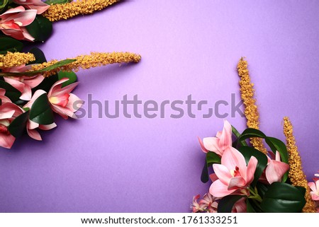 Top view of flowers over purpler background.