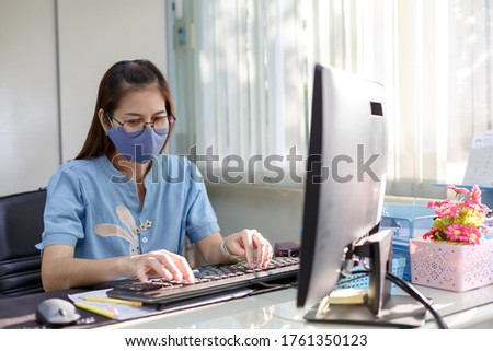 Female employee wears face mask in customer service for measures to prevent virus covid-19