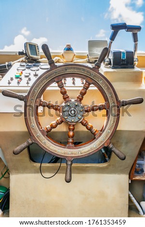 Beautiful view of a vintage Ship's wheel control panel background in a blue sky day