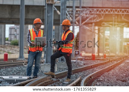 The  engineer stand discussion  on rails. worker  work on railway. construction,engineer,workers ,rail,Infrastructure Royalty-Free Stock Photo #1761355829