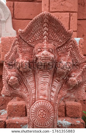 Red five-headed Naga statue in temple