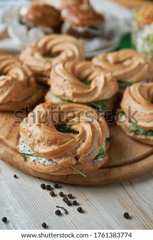 Round bagels with cucumber and herbs on a wooden Board. Close-up. light effects