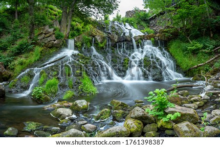 Long Exposure Waterfall in Lush Forest by the Old Watermill In rural Village Rottle By near Granna In Swedish Smaland, Sweden. 