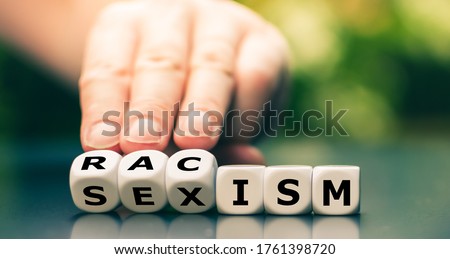 Dice form the words "racism" and "sexism". Royalty-Free Stock Photo #1761398720