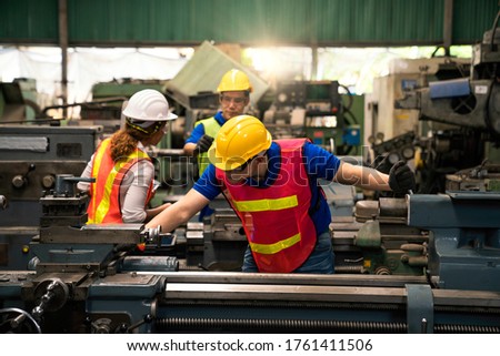 An expert technician is inspecting industrial machinery in a steel factory. Engineers are working and repairing machines in industrial. Technician holding Measuring pliers. Royalty-Free Stock Photo #1761411506